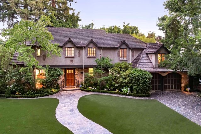 a front view of a house with a garden
