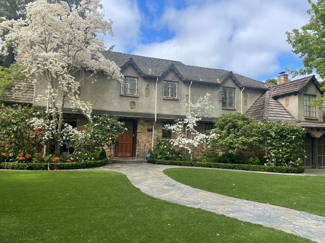 a front view of a house with a garden
