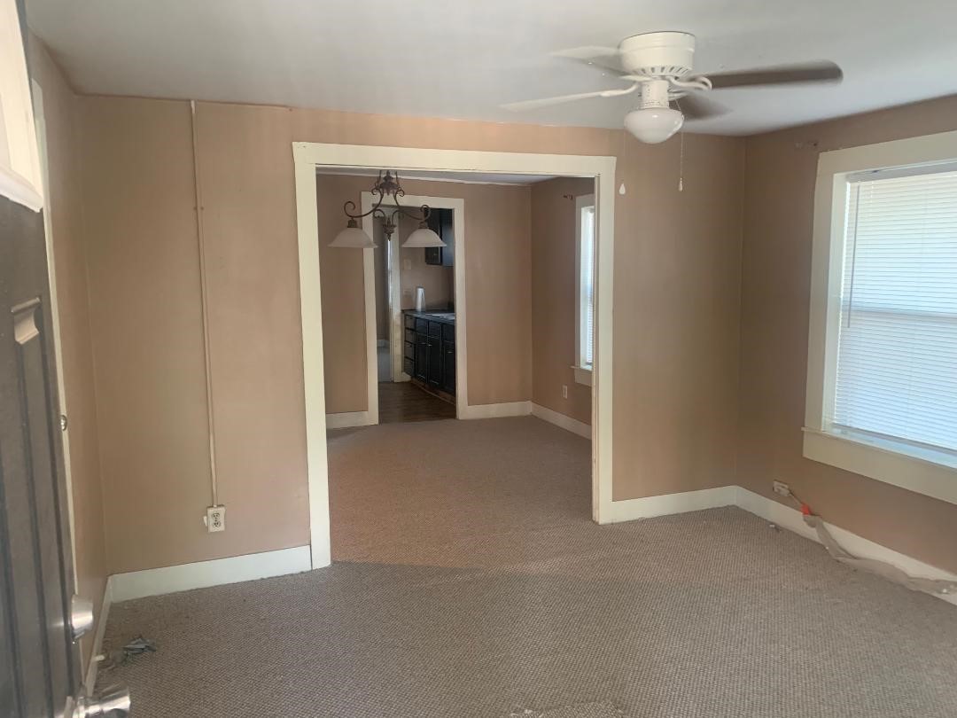 110 Peeples Street Navasota, TX 77868 - Photo 2 of 7 an empty room that has a window in it
