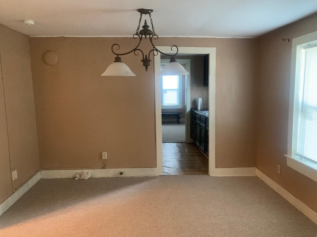 110 Peeples Street Navasota, TX 77868 - Photo 4 of 7 a view of a room with a empty space and windows