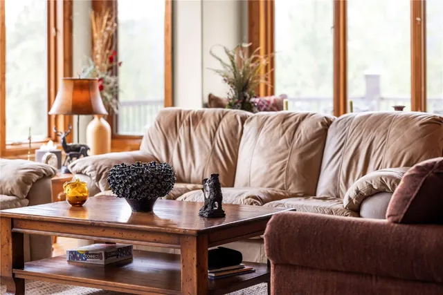 a bedroom with furniture and a large window
