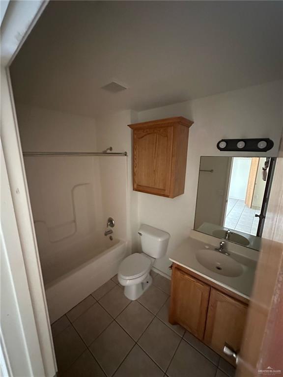 901 English Avenue, Unit 3 Edinburg, TX 78541 - Photo 7 of 9 a bathroom with a granite countertop sink mirror vanity and toilet