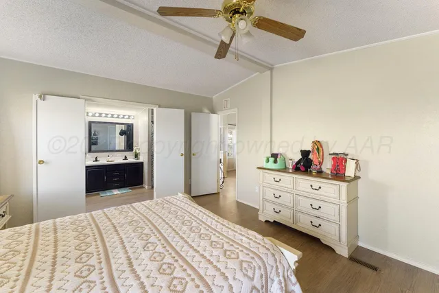 a bedroom with a bed and a dresser