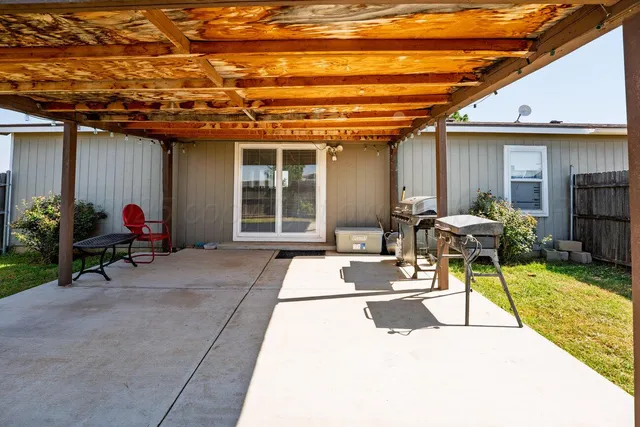 a view of a patio with table and chairs potted plants and a chair
