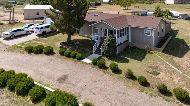 an aerial view of a house with a yard