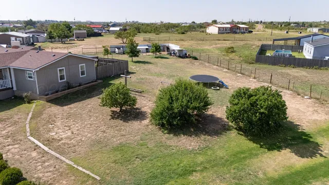 an aerial view of a house with a yard
