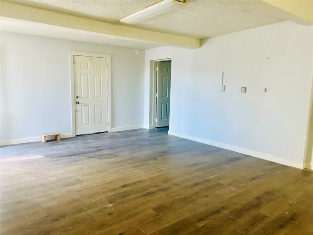 an empty room with wooden floor and closet