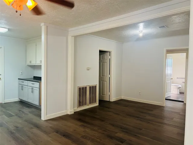 a view of a kitchen with wooden floor and a sink