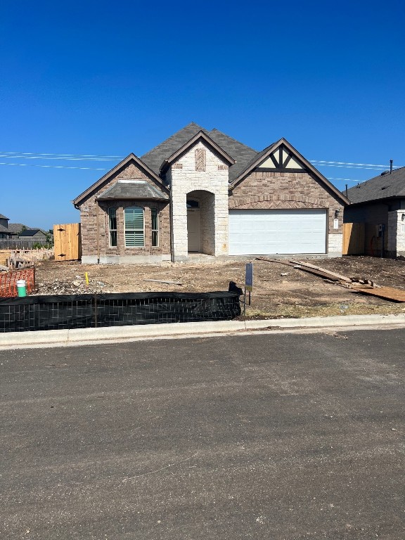a view of a house with a yard and large tree