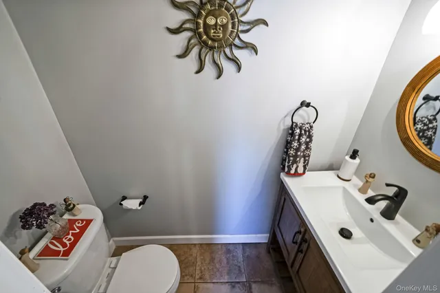 a bathroom with a sink mirror and toilet