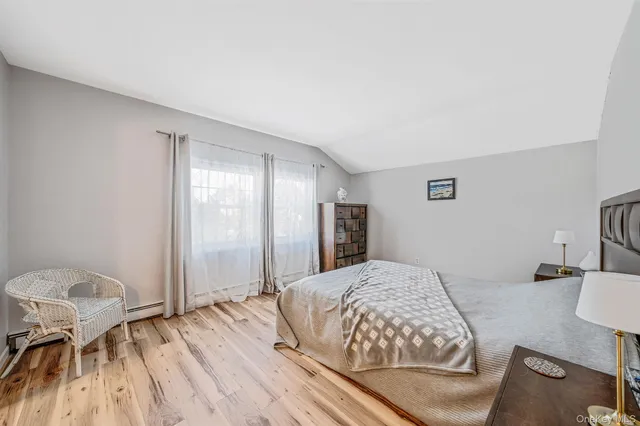 a bedroom with a bed and a chair in it