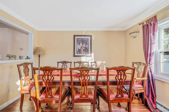 a dining room with furniture and wooden floor