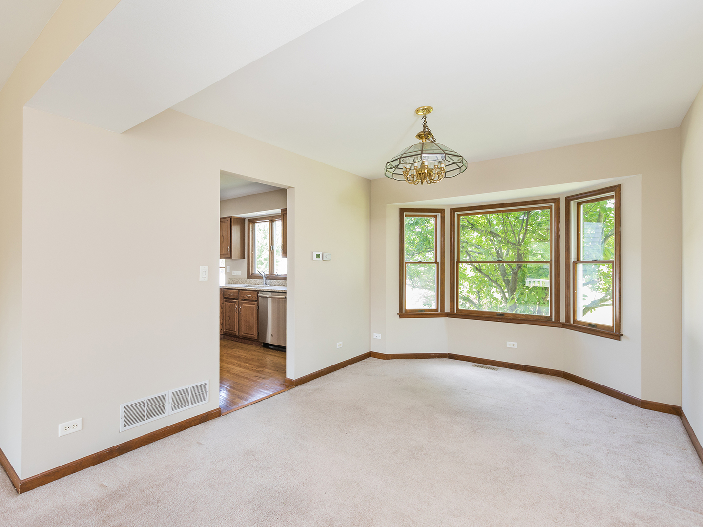 872 New Britton Road Carol Stream, IL 60188 - Photo 6 of 22 an empty room with chandelier and windows