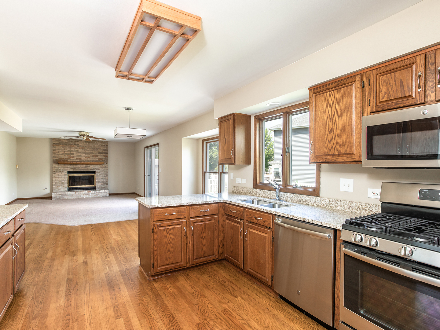 872 New Britton Road Carol Stream, IL 60188 - Photo 7 of 22 a kitchen with stainless steel appliances granite countertop a sink and stove top oven