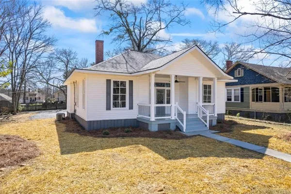a front view of a house with a yard covered in snow