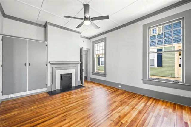 a view of a livingroom with wooden floor and a ceiling fan