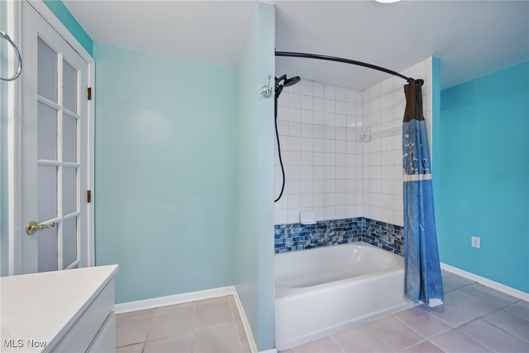 28575 White Road Wickliffe, OH 44092 - Photo 32 of 49 Full bathroom featuring tile patterned floors, shower / bath combo with shower curtain, vanity, and baseboards