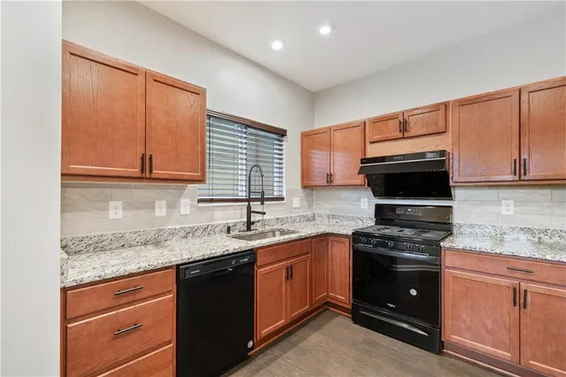 a kitchen with stainless steel appliances granite countertop a sink stove and microwave