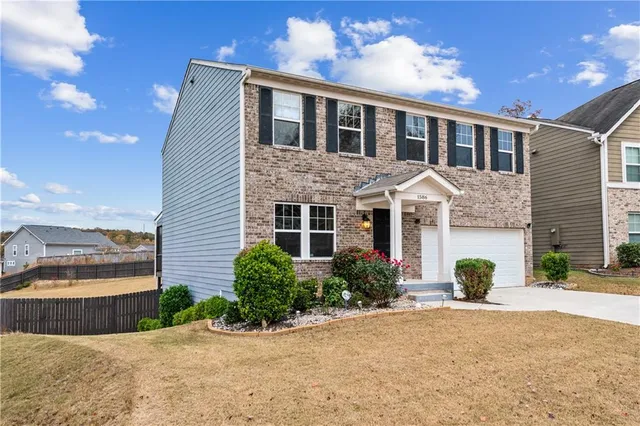 a front view of a house with a yard