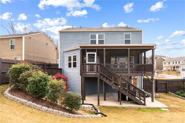 a view of a house with sitting area and swimming pool