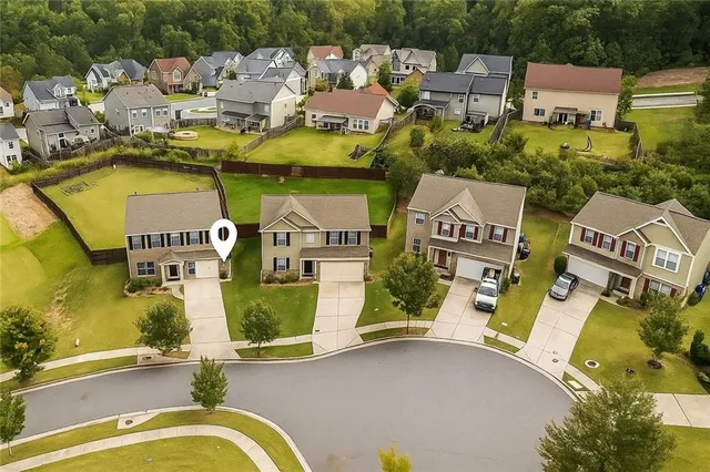 an aerial view of a house with swimming pool and outdoor seating