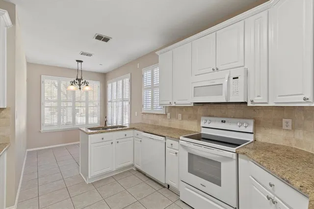 a kitchen with a sink stove and cabinets