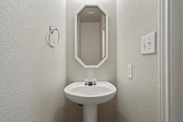 a bathroom with a sink a mirror and vanity