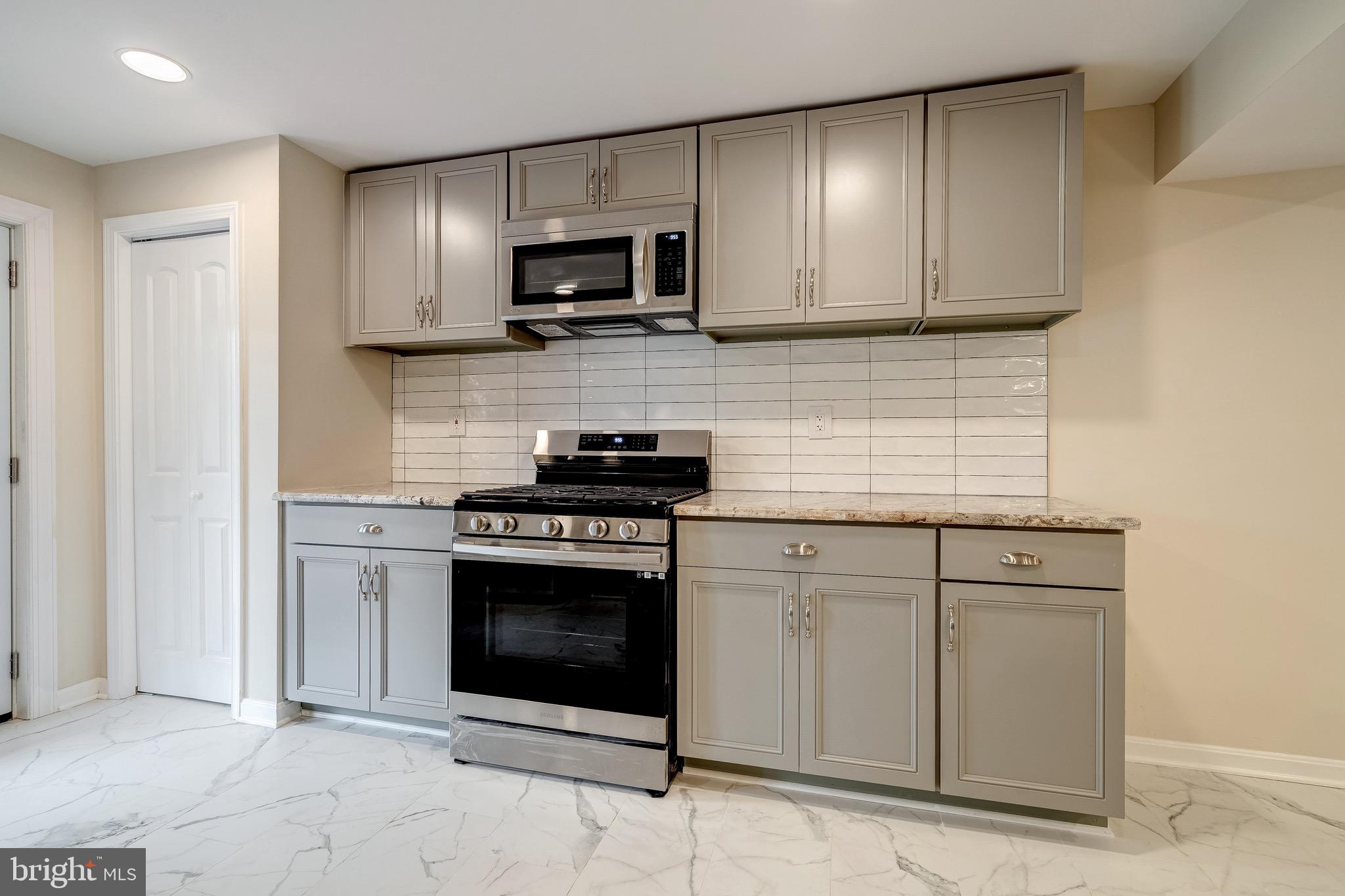 6042 Munson Hill Road Falls Church, VA 22044 - Photo 11 of 30 a kitchen with white cabinets stainless steel appliances and sink
