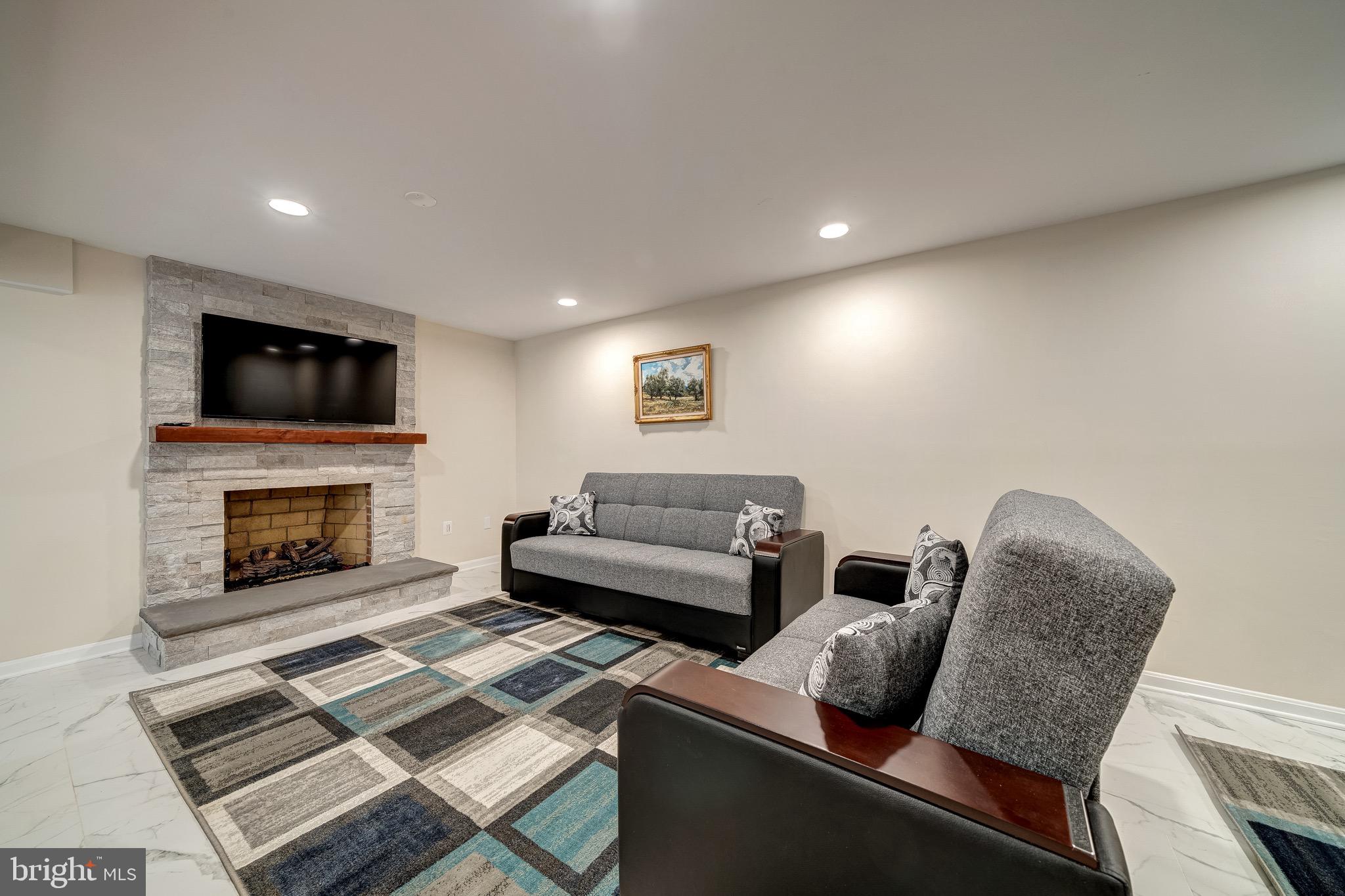 6042 Munson Hill Road Falls Church, VA 22044 - Photo 16 of 30 a living room with furniture and a fireplace