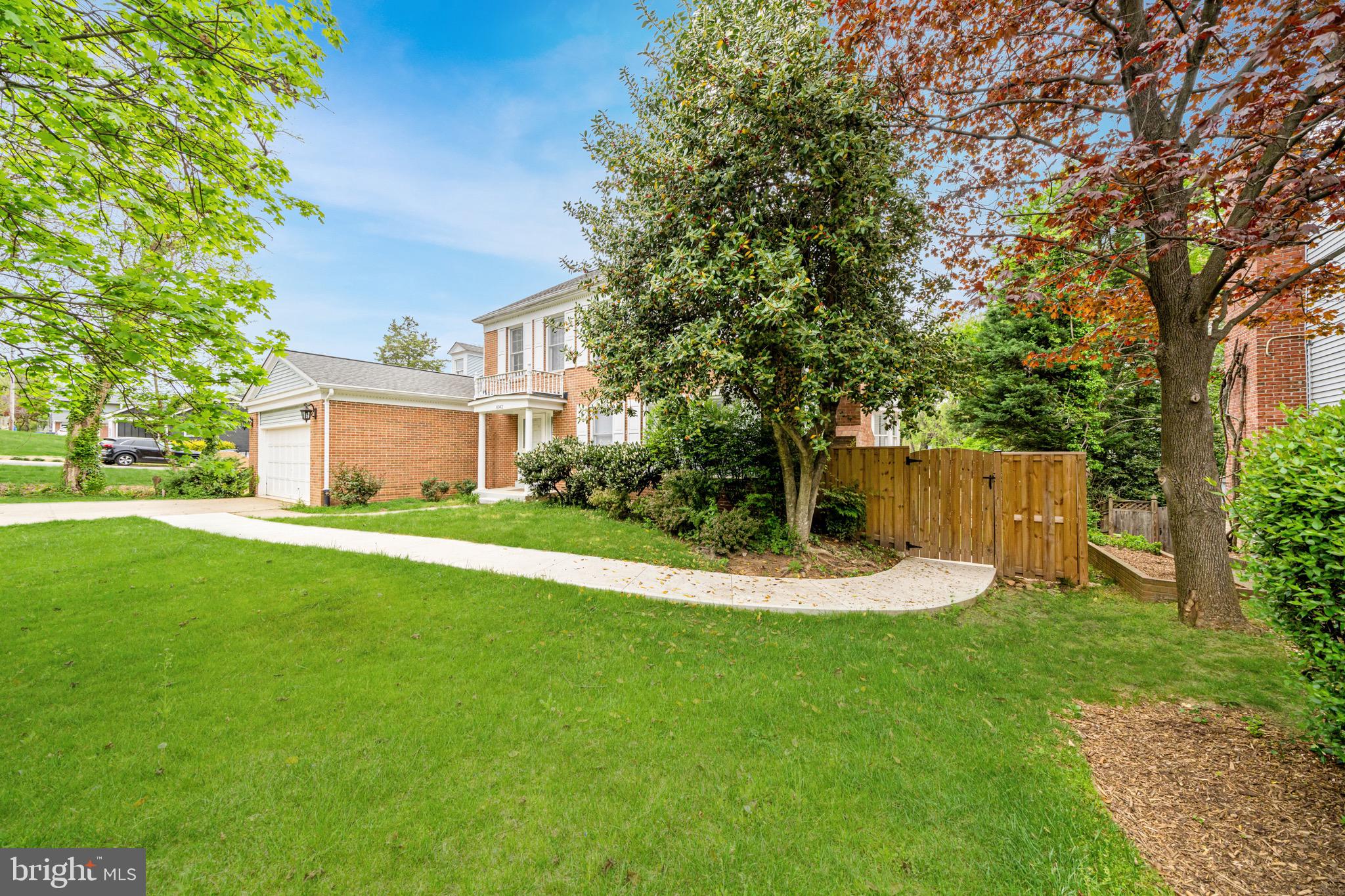 6042 Munson Hill Road Falls Church, VA 22044 - Photo 2 of 30 a front view of a house with a yard and trees