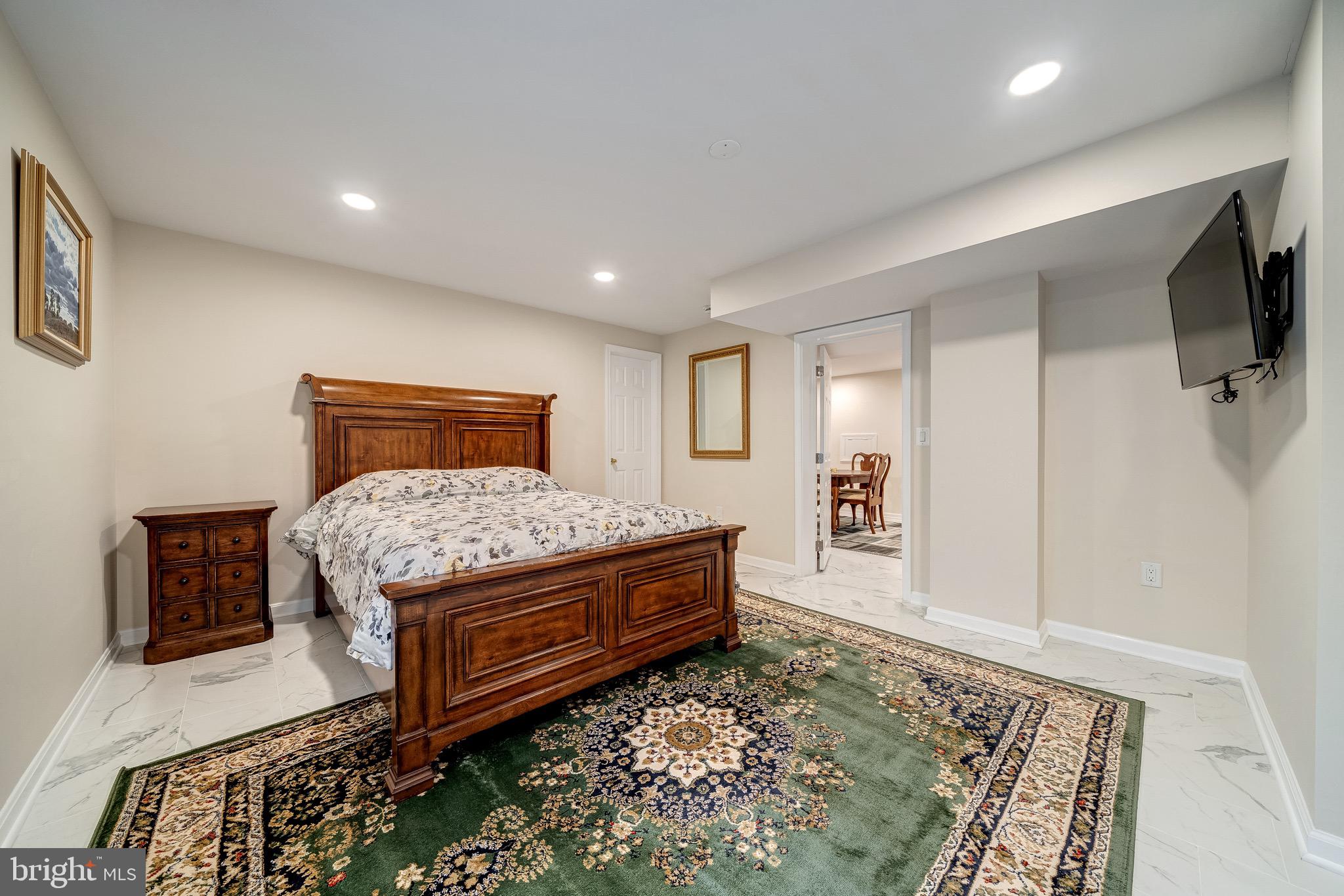 6042 Munson Hill Road Falls Church, VA 22044 - Photo 21 of 30 a bedroom with a bed and flat screen tv