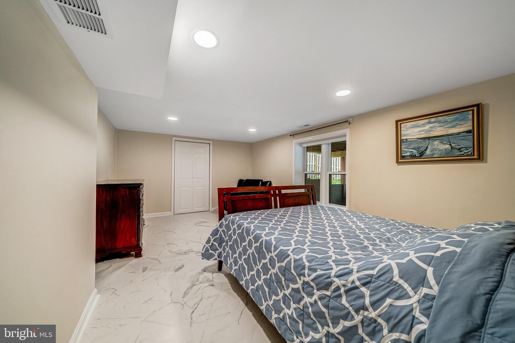 6042 Munson Hill Road Falls Church, VA 22044 - Photo 24 of 30 a bedroom with a large bed and a painting