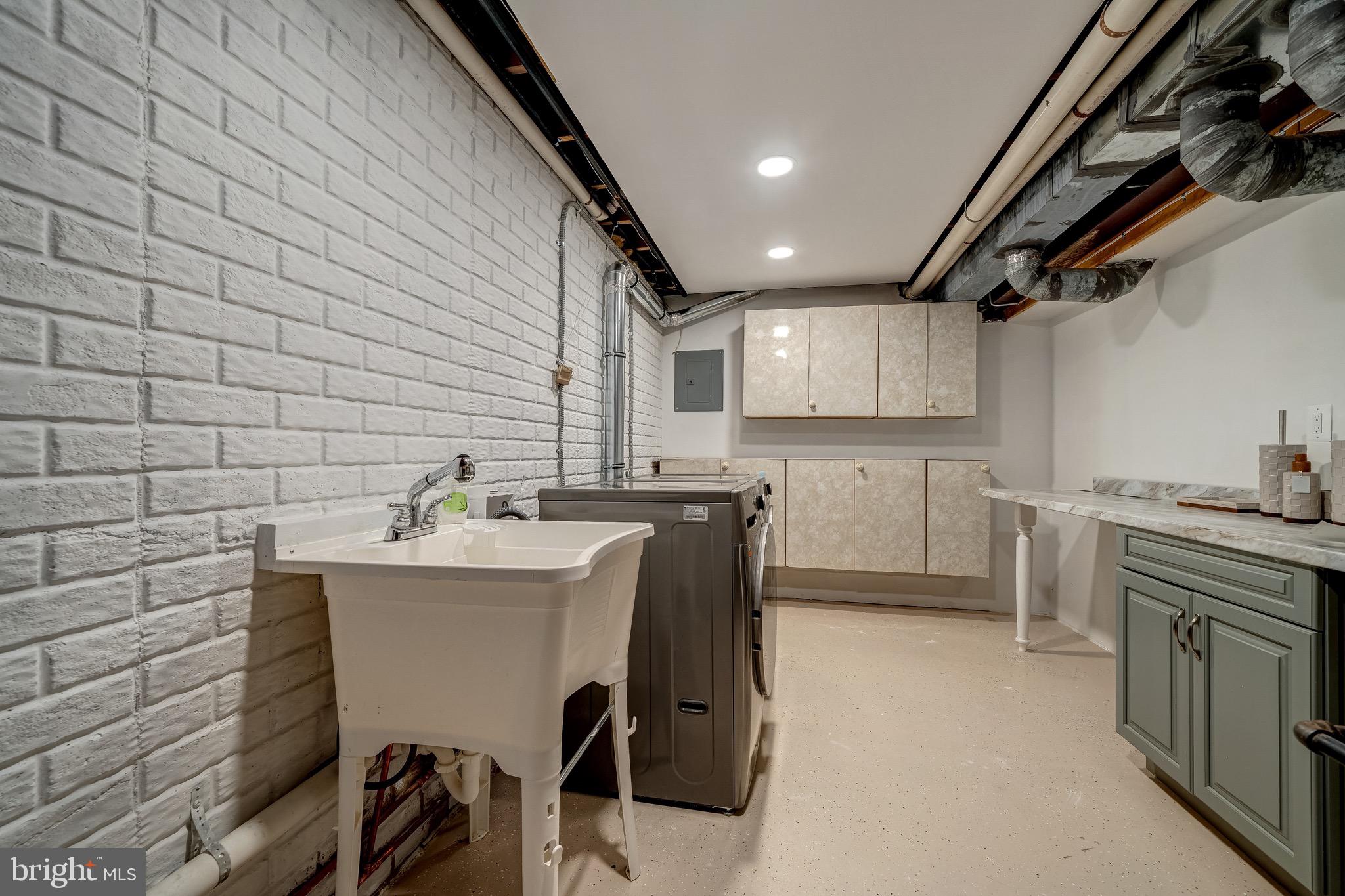 6042 Munson Hill Road Falls Church, VA 22044 - Photo 29 of 30 a kitchen with a sink a window cabinets and stainless steel appliances
