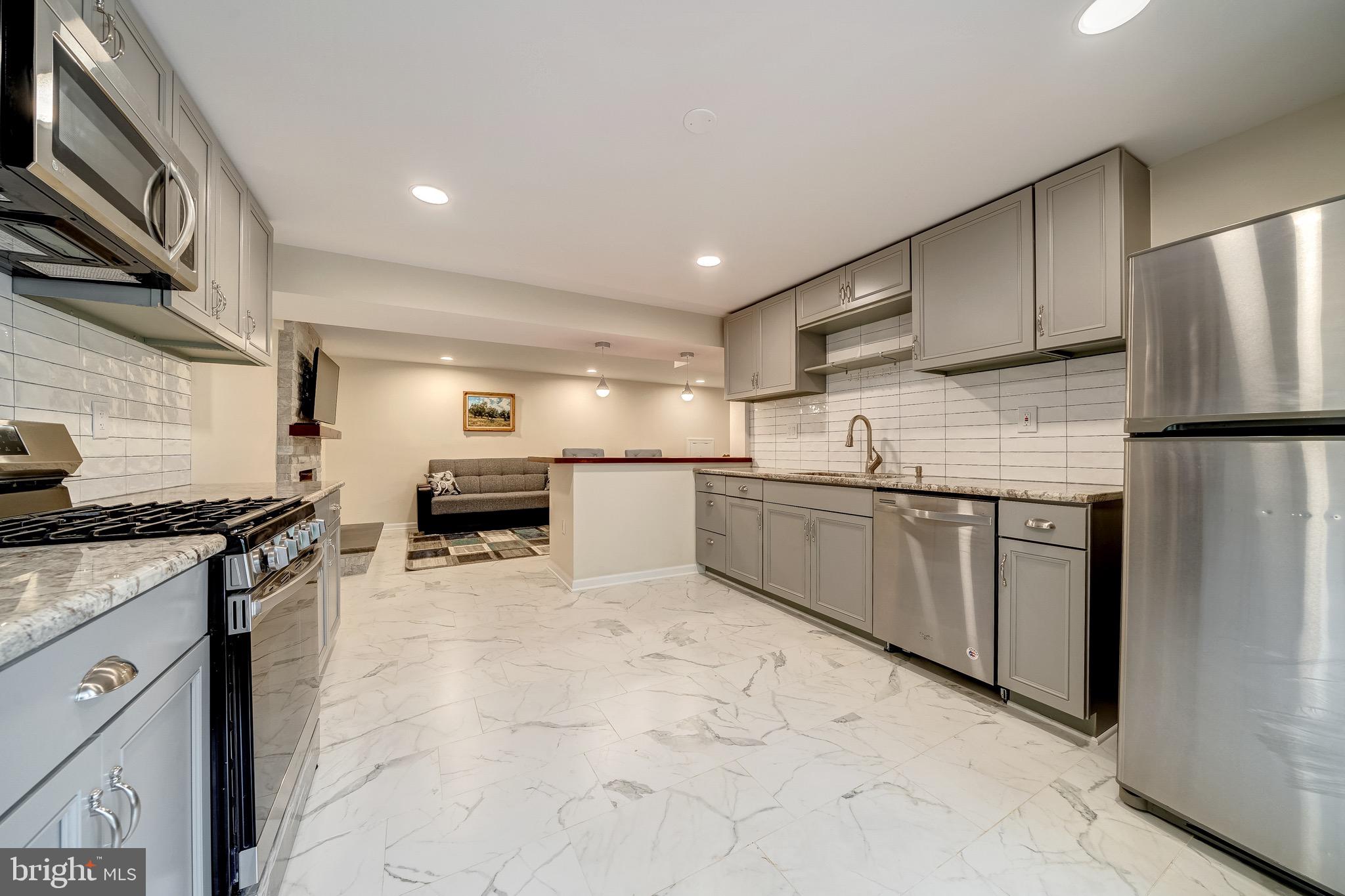 6042 Munson Hill Road Falls Church, VA 22044 - Photo 9 of 30 a kitchen with granite countertop a sink stainless steel appliances and cabinets