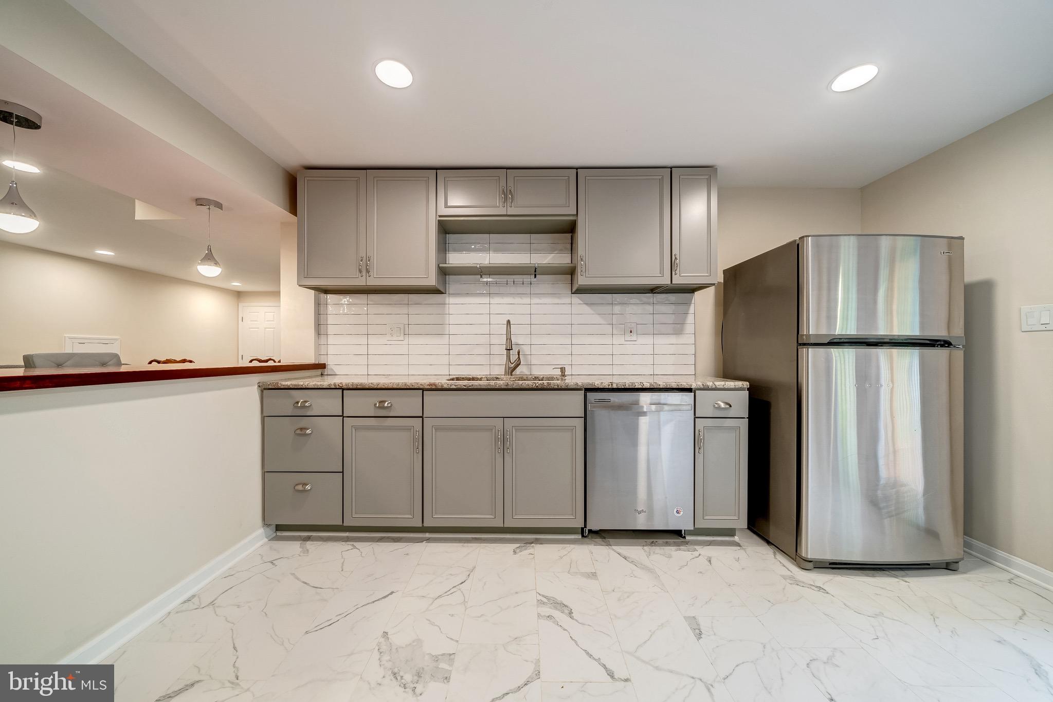 6042 Munson Hill Road Falls Church, VA 22044 - Photo 10 of 30 a kitchen with stainless steel appliances granite countertop a refrigerator a stove and a sink