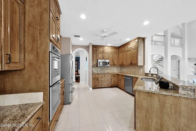a front view of a house with garden and trees