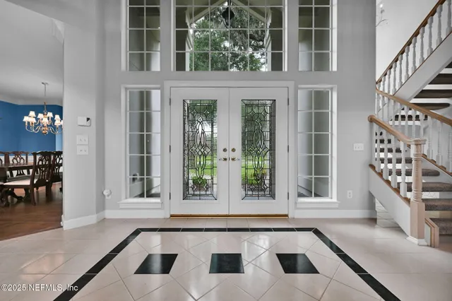 a living room with fireplace furniture and a large window