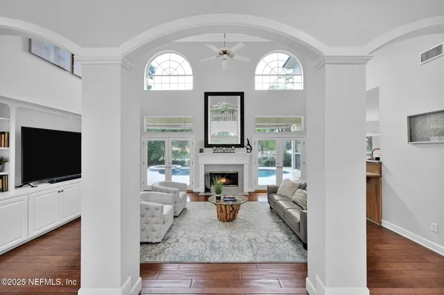 a view of a dining room with furniture a chandelier and wooden floor