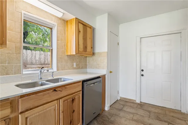 a kitchen with a sink cabinets and window