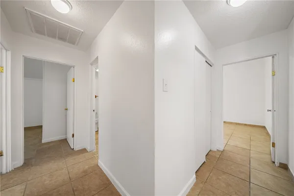 a view of a hallway with closet area