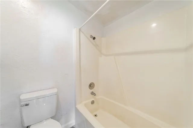 a bathroom with a bathtub and a toilet