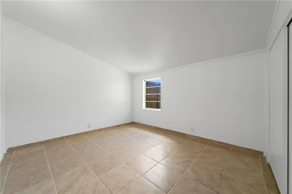 an empty room with a empty space and windows
