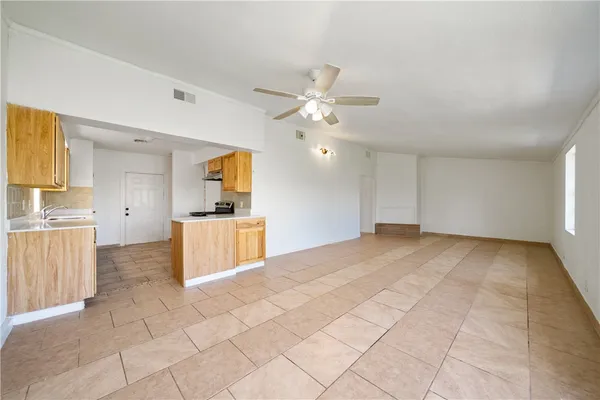 a view of a kitchen with a sink and a stove top oven