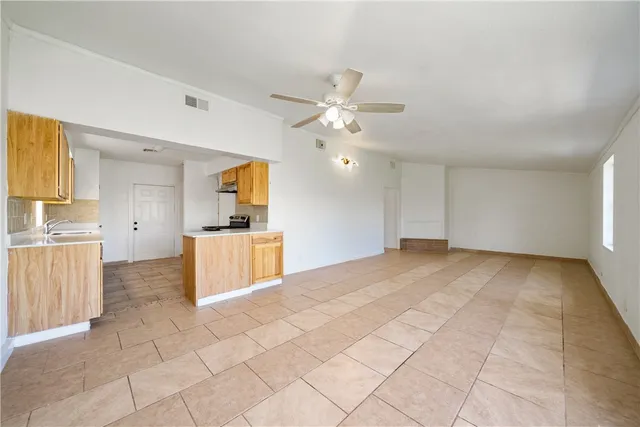 a view of a kitchen with a sink and a stove top oven