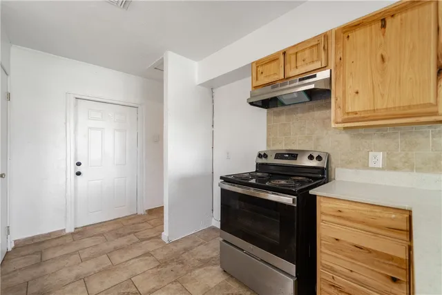 a kitchen with stainless steel appliances granite countertop a stove and a refrigerator