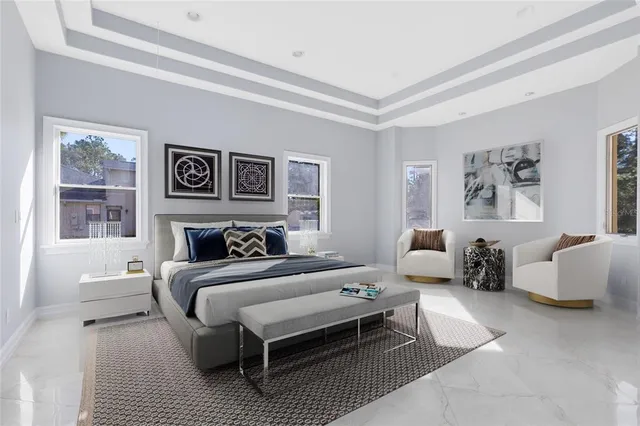 a living room with a bed and a flat screen tv