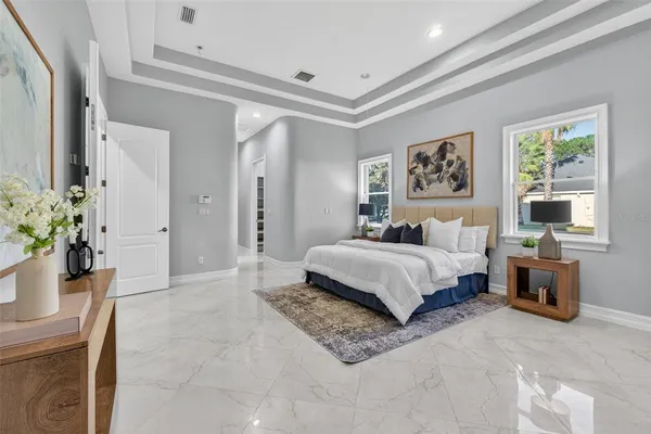 a large bathroom with a granite countertop sink a large mirror and a bathtub