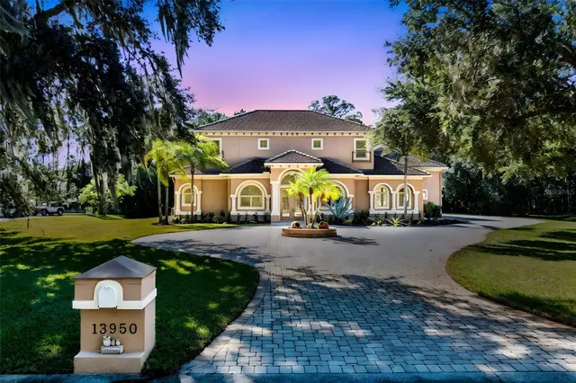 a front view of a house with garden and swimming pool