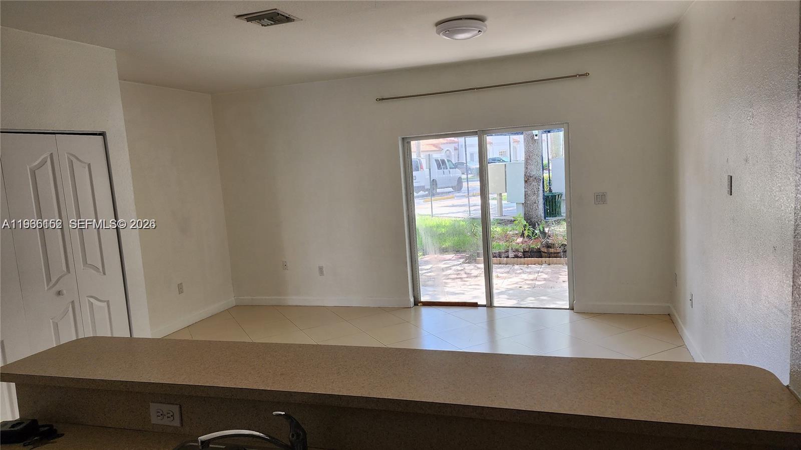8450 Southwest 150th Avenue, Unit 3 Miami, FL 33193 - Photo 12 of 28 an empty room with wooden floor and windows