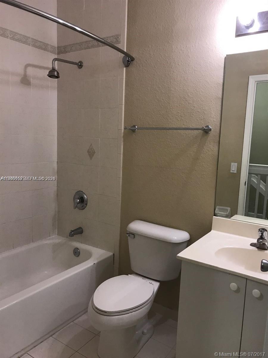 8450 Southwest 150th Avenue, Unit 3 Miami, FL 33193 - Photo 16 of 28 a white toilet sitting next to a bath tub